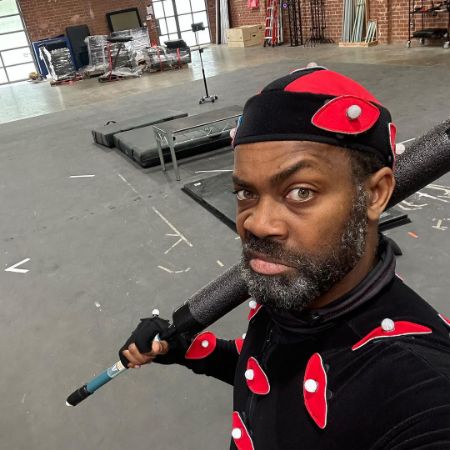 Damion Poitier is posing with a bad in the gym.